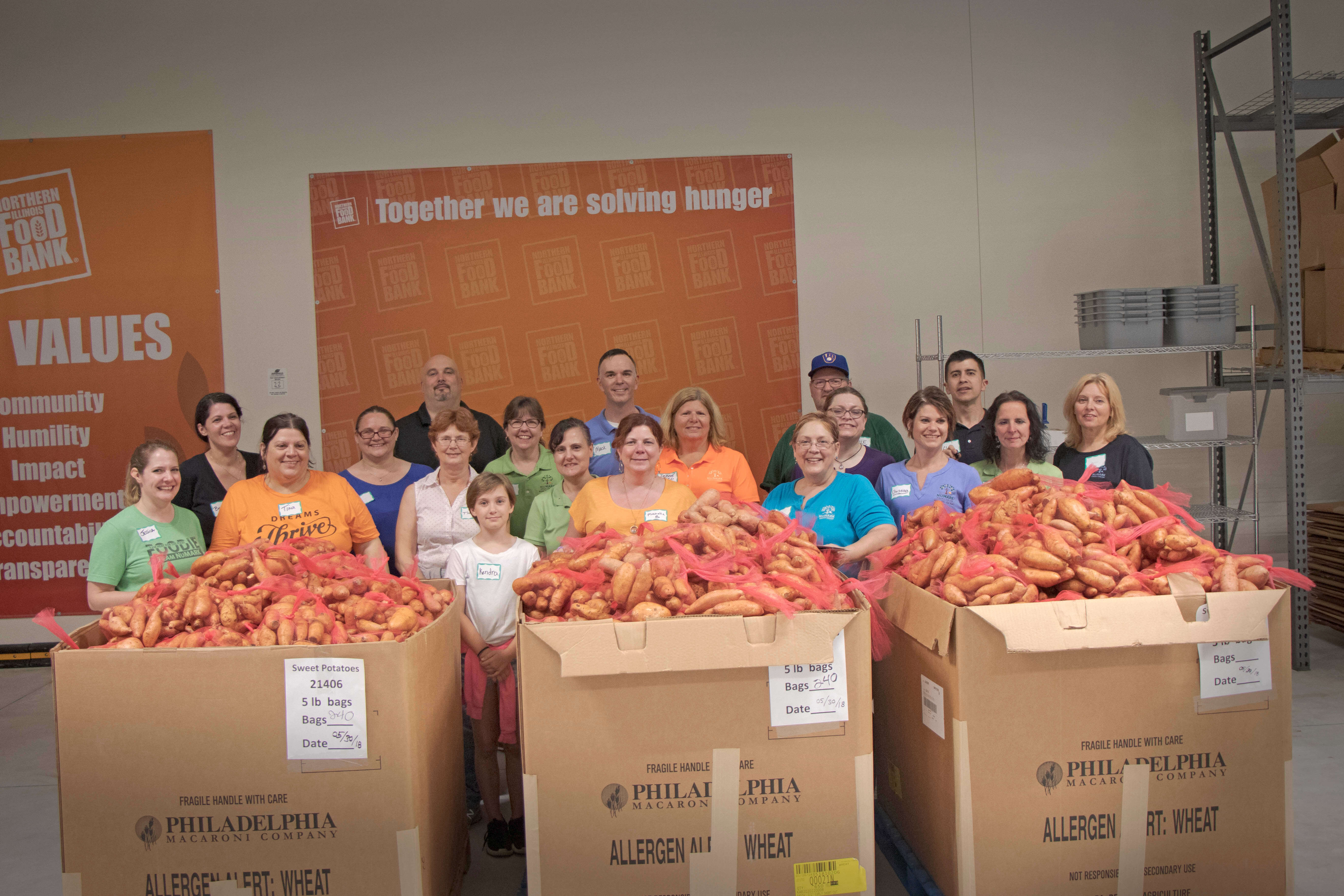 Volunteers with boxes of potatoes packed