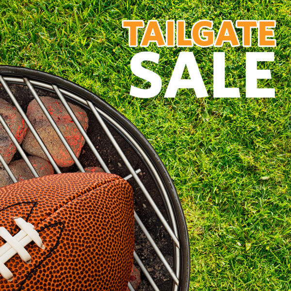 Football on barbeque gril placed on grass