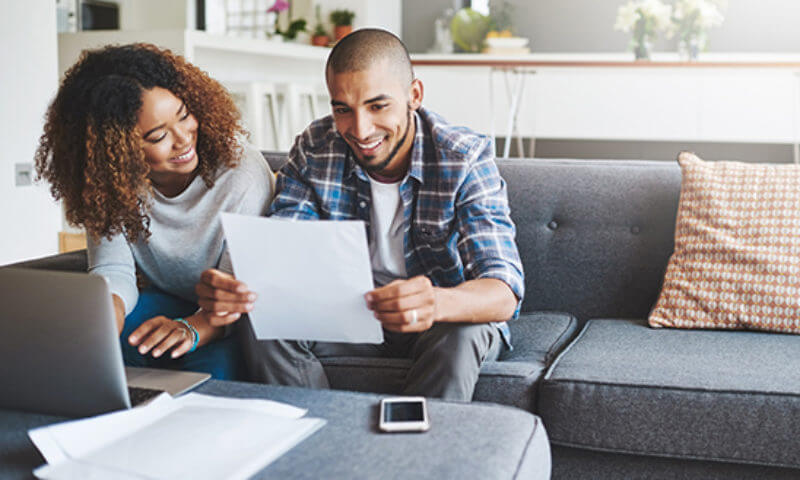 a man and a woman looking at a piece of paper