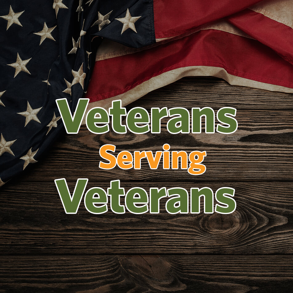 American flag on a wooden table with words overlapping that say Veterans Serving Veterans