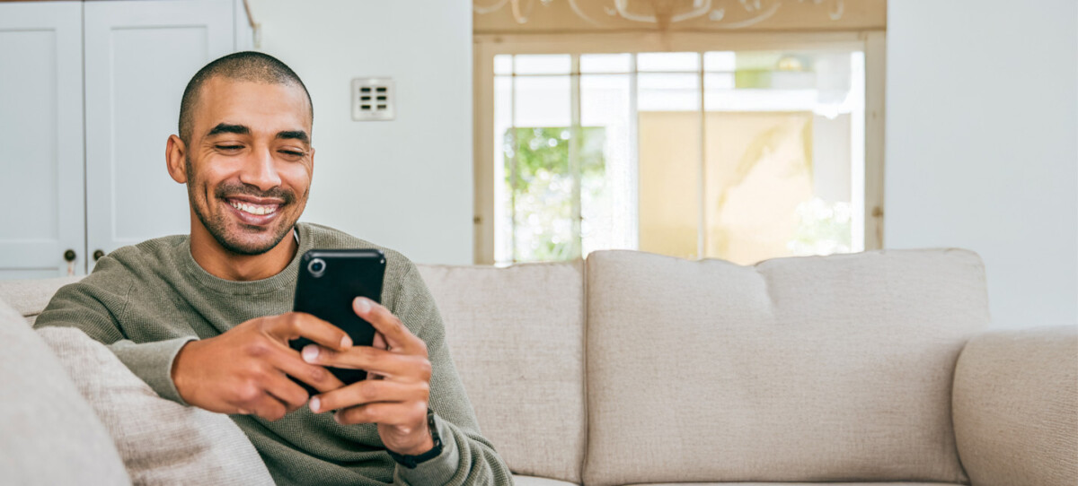 Man on couch with mobile phone