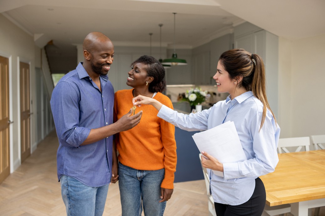 African American couple being handed keys