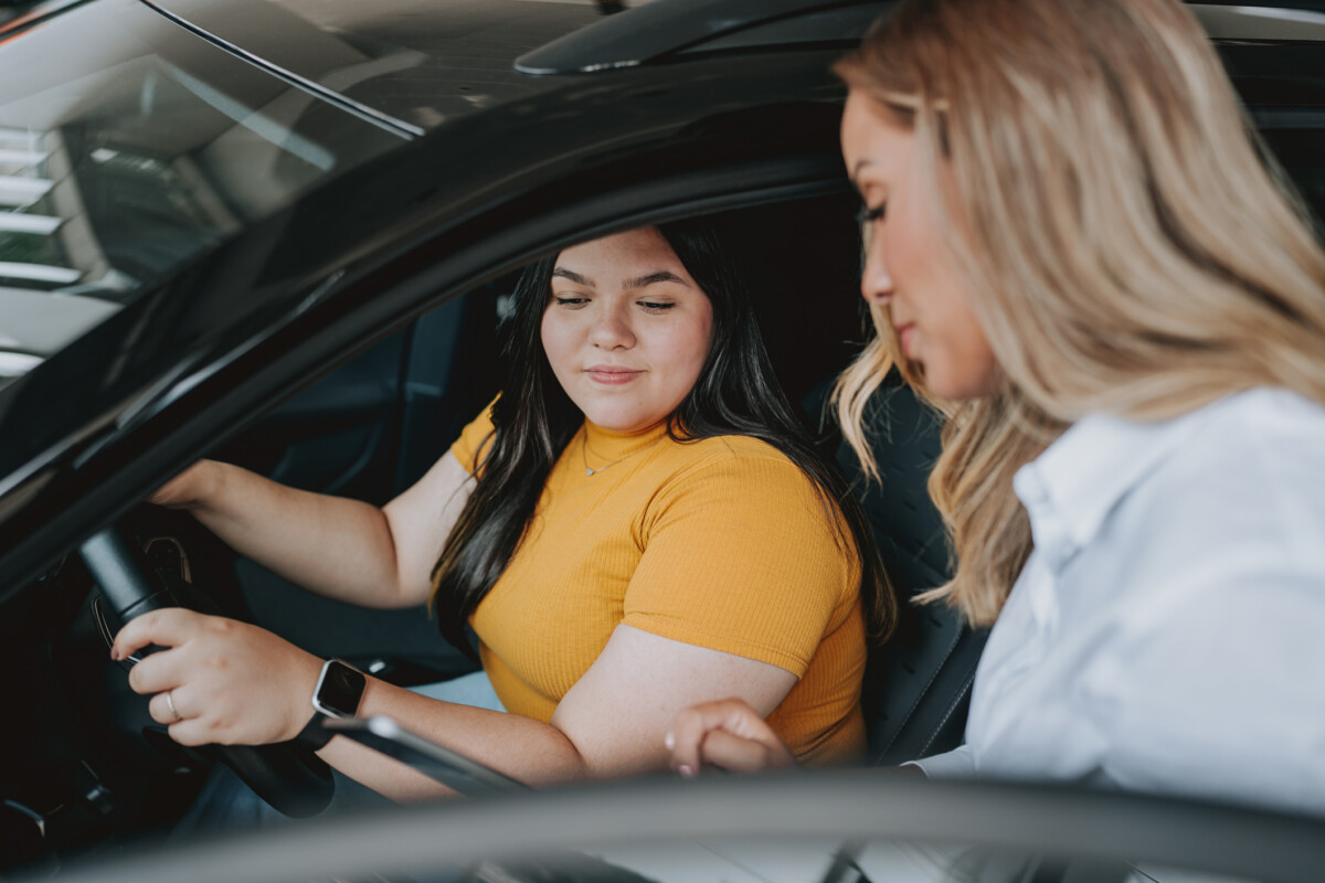 Young Adult female at car dealership