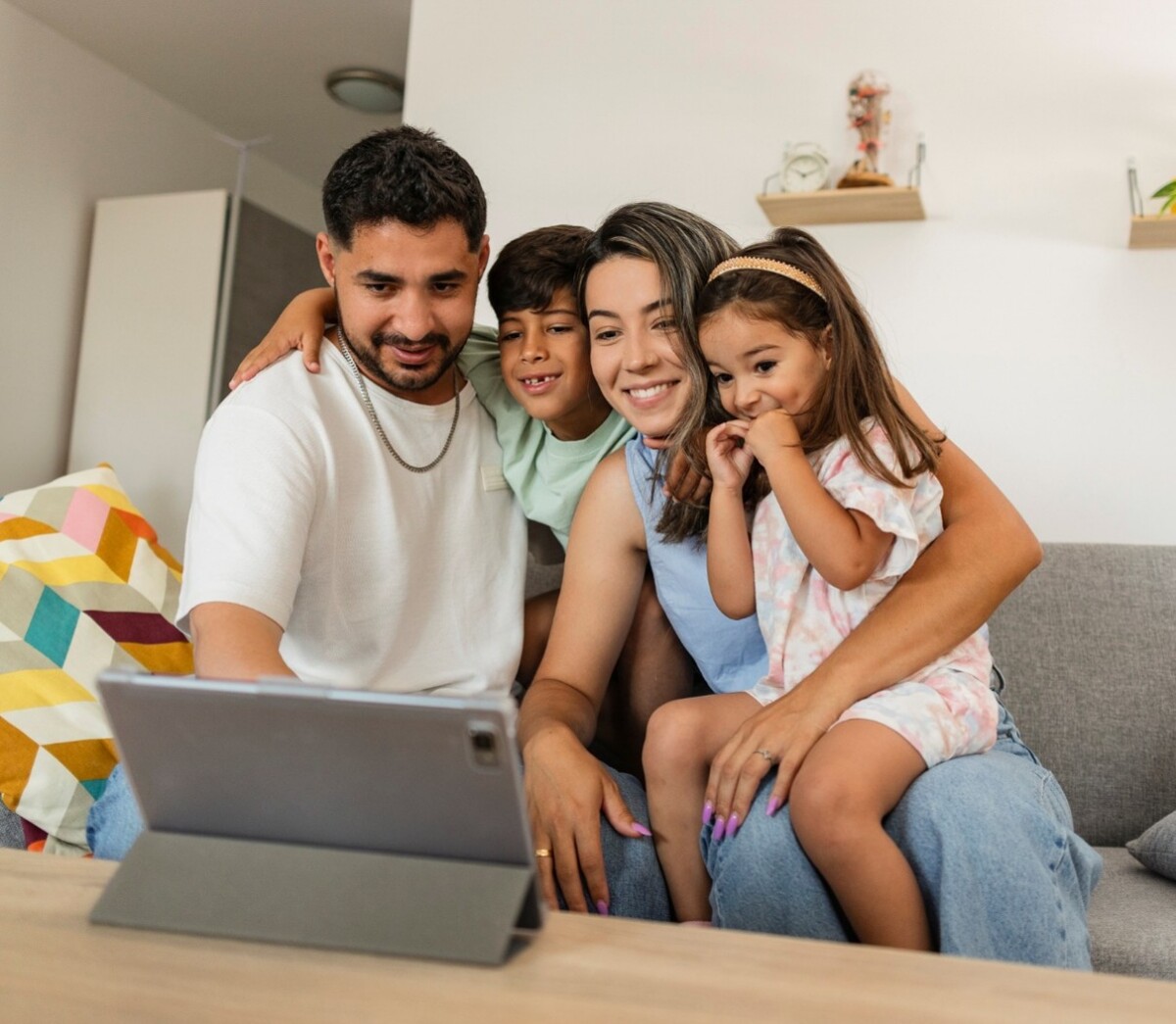 Hispanic family around a tablet device