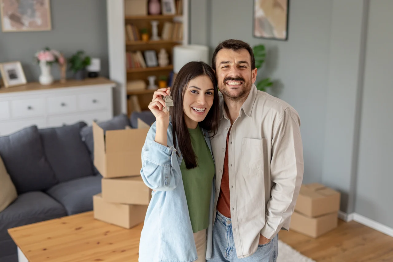 Couple holding keys in their new home