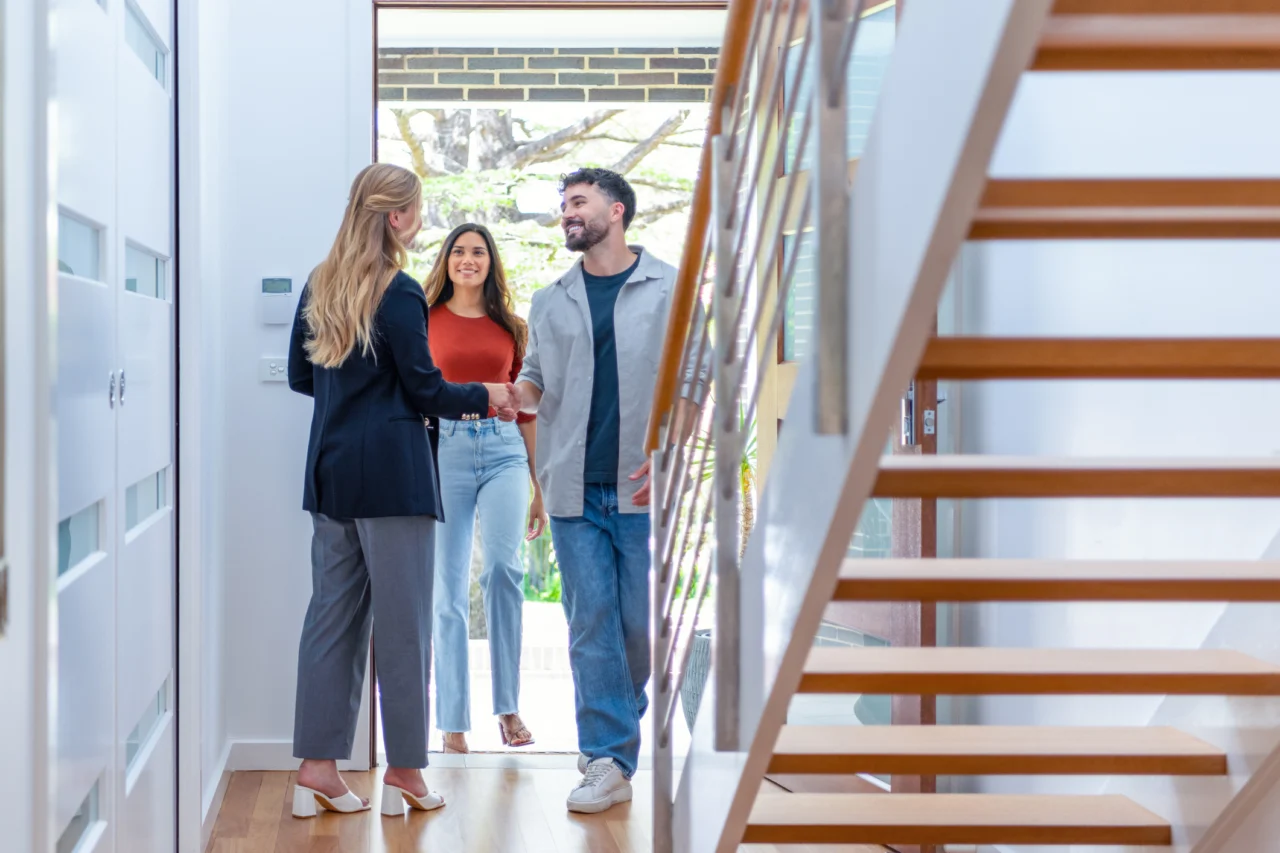 Couple walking into home meeting with relator