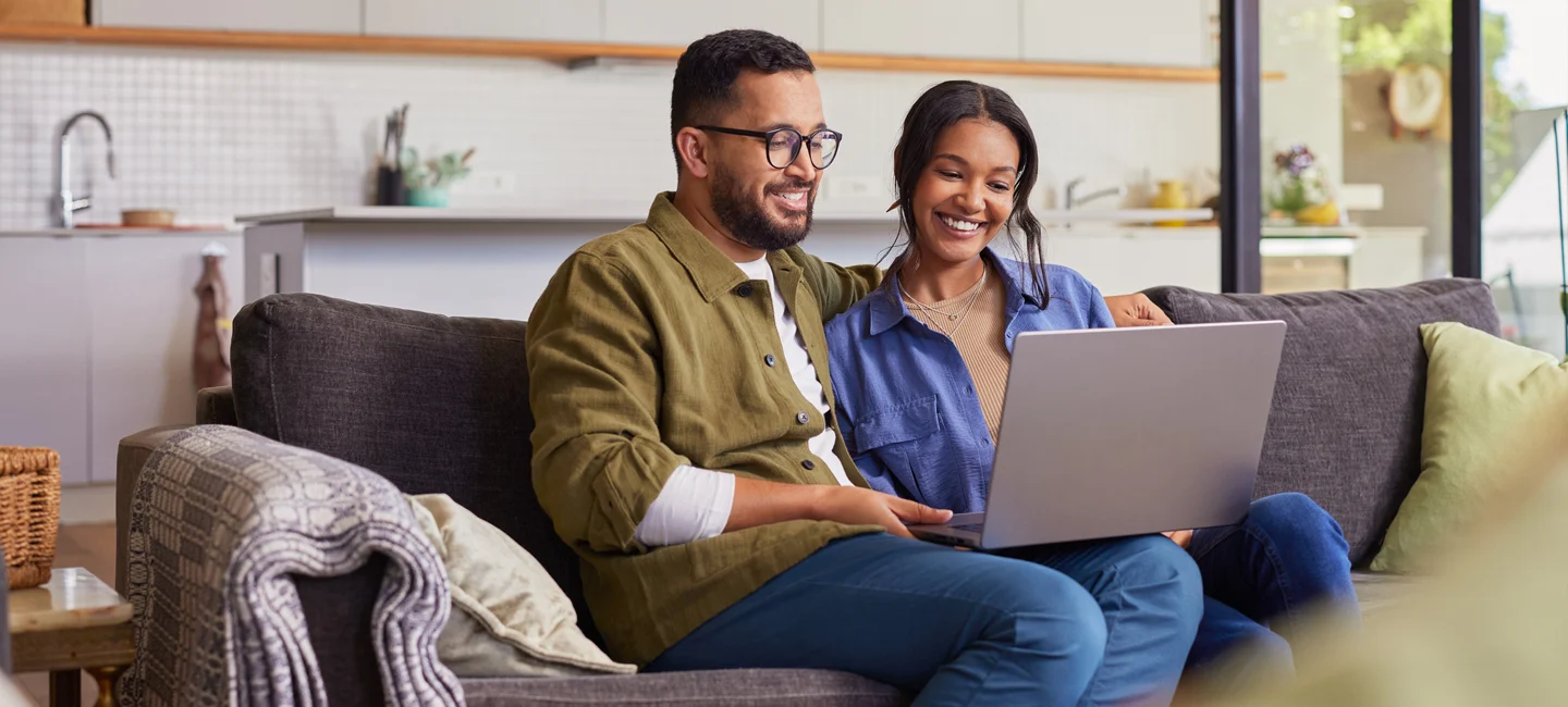 couple on couch with laptop