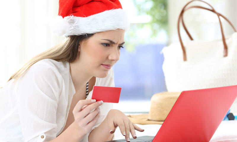 Shopper using NuMark Credit Union Online Banking to avoid holiday fraud