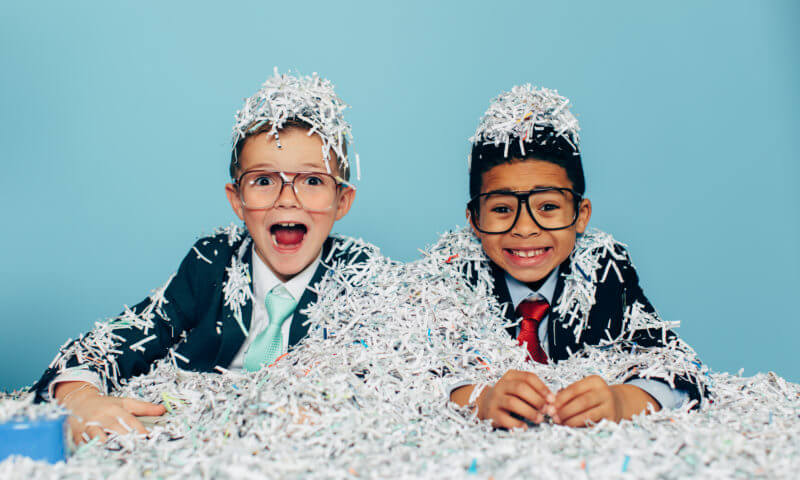 Kids covered in shredded paper